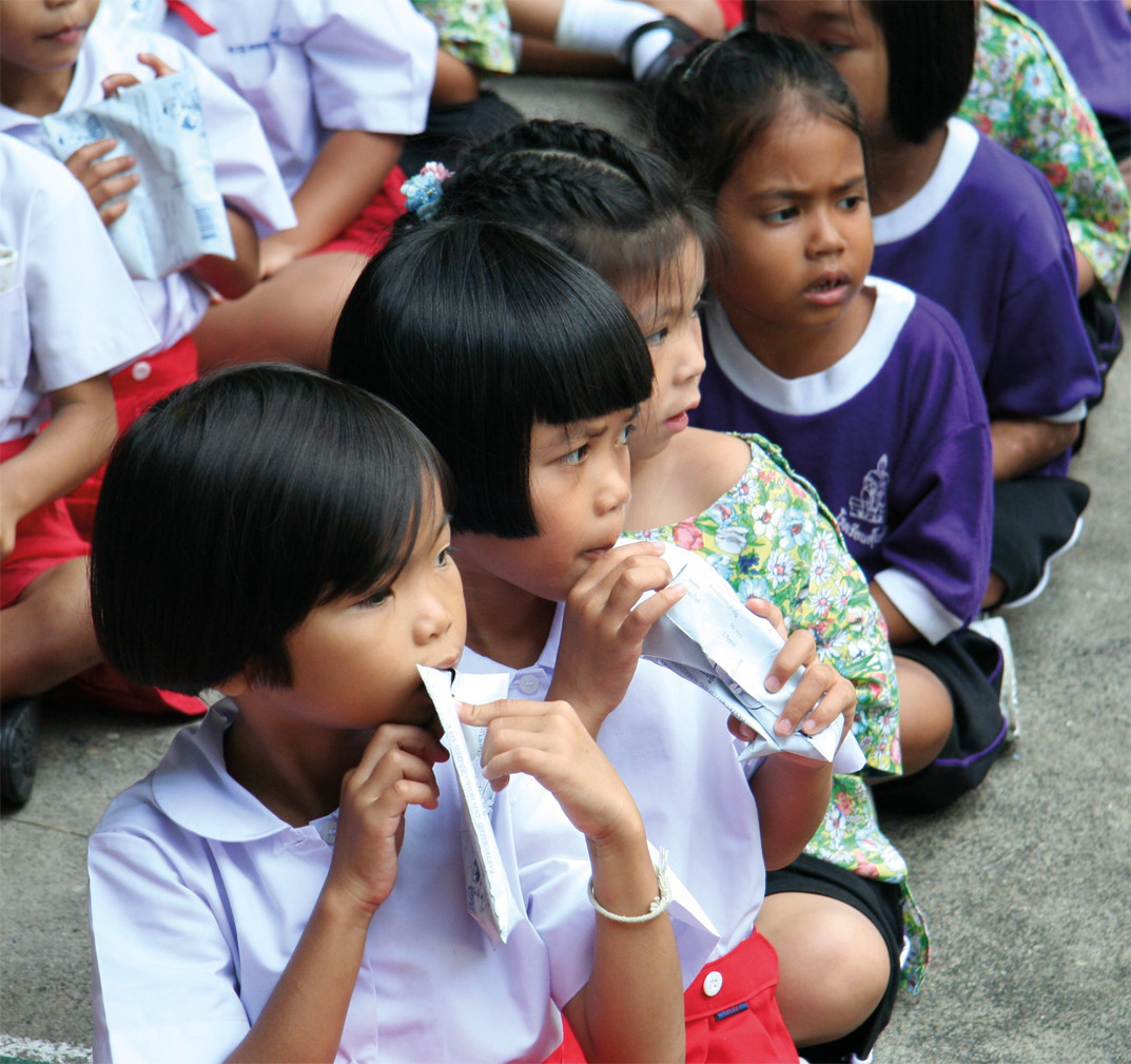 Photograph of schoolchildren enjoying a snack