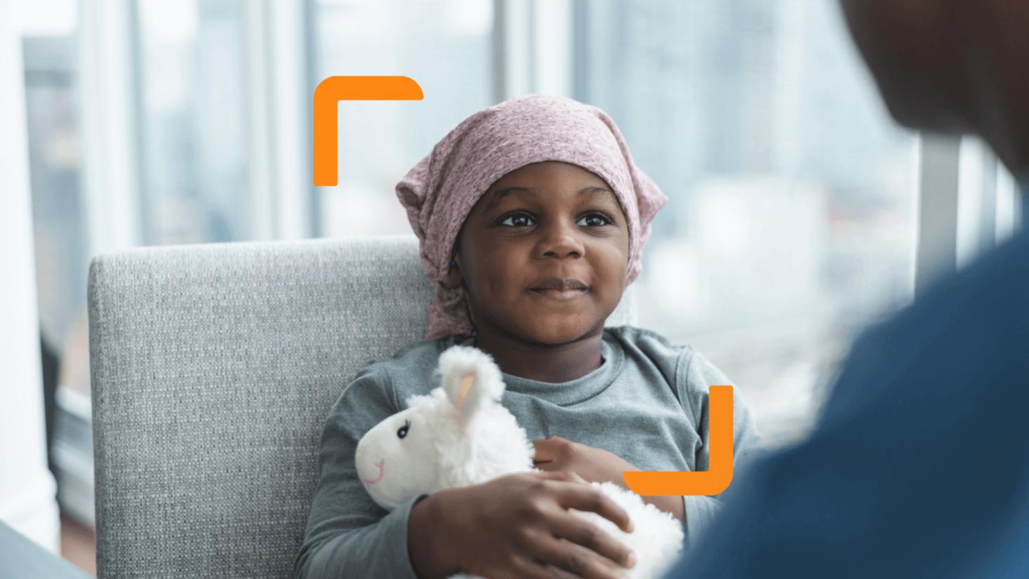 Child holding a fluffy toy framed by the arm device created as part of the Children with Cancer UK charity branding, created by charity design agency Studio Republic