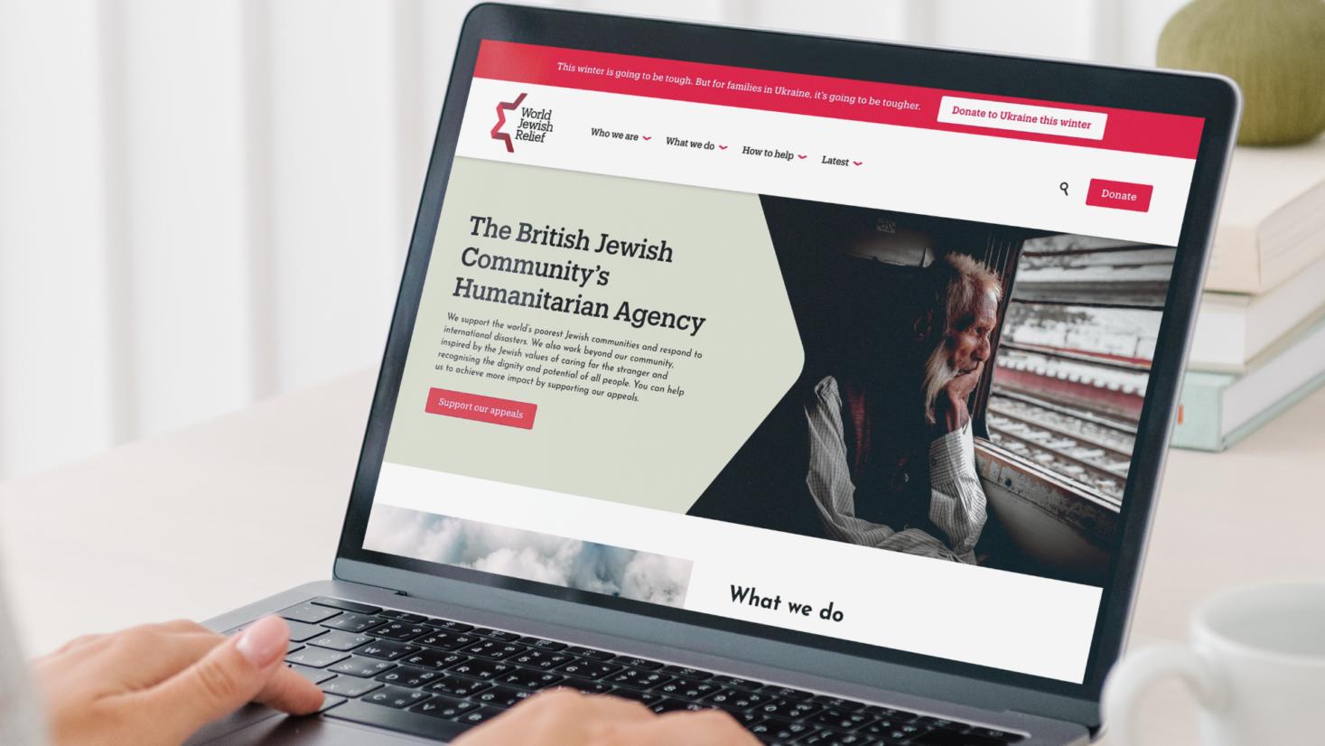 A person viewing the new World Jewish Relief charity website design on their laptop.