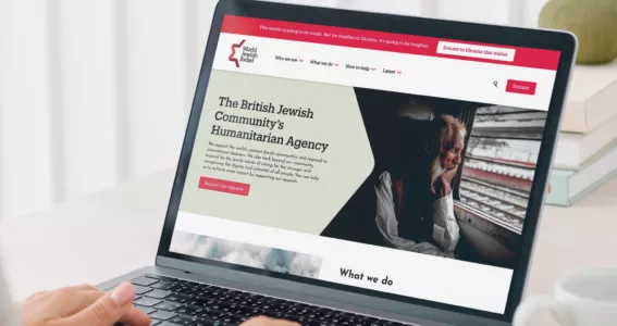 A person viewing the new World Jewish Relief charity website design on their laptop, created by charity design agency Studio Republic