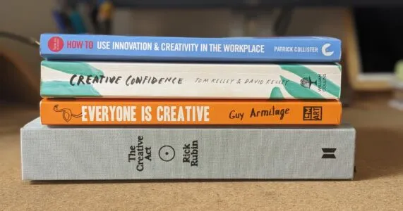 A pile of 4 books on a desk, on the topic of creativity